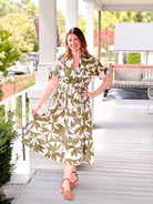 olive green dress with short sleeves, midi length, leaf pattern