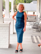 form fitting teal dress, sleeveless