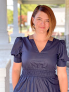 midi length dark navy dress with brown floral design and v neckline