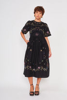 black midi length short sleeve dress with colorful embroidery 