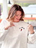 sweatshirt with red chili and "I'm a little chili" written on front left 
