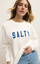 white sweatshirt that says "Salty" in blue letters