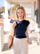 fitted navy top with ruffle sleeves