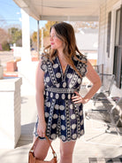 navy romper with white eyelet detailing