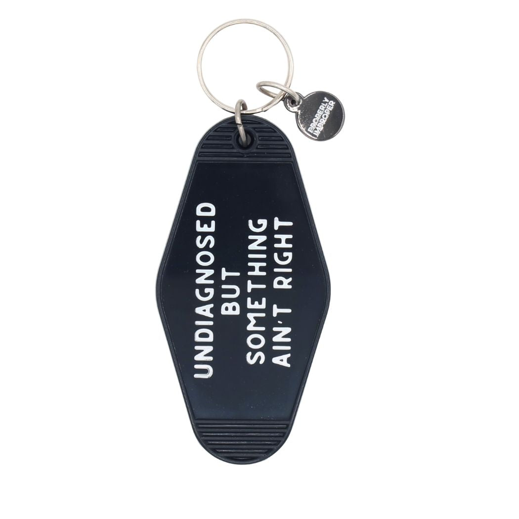 Black Keychain that says "Undiagnosed but something ain't right"